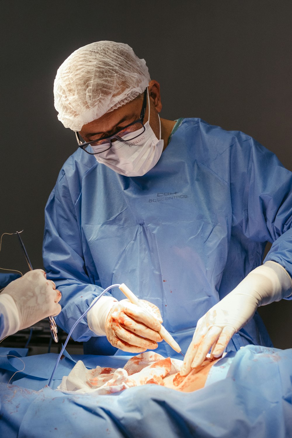 a surgeon performing surgery on a patient in an operating room