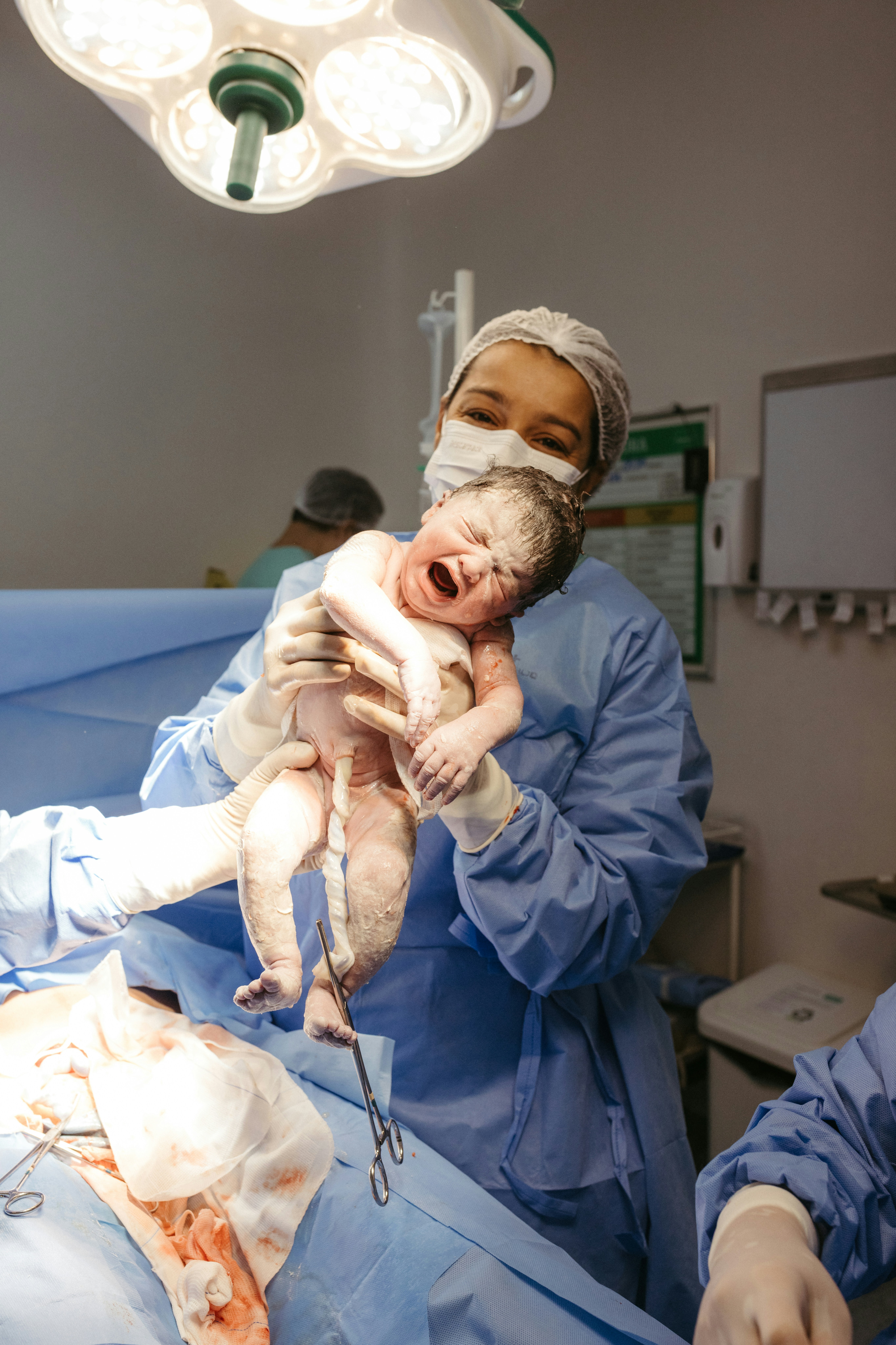 a man holding a baby in a hospital room