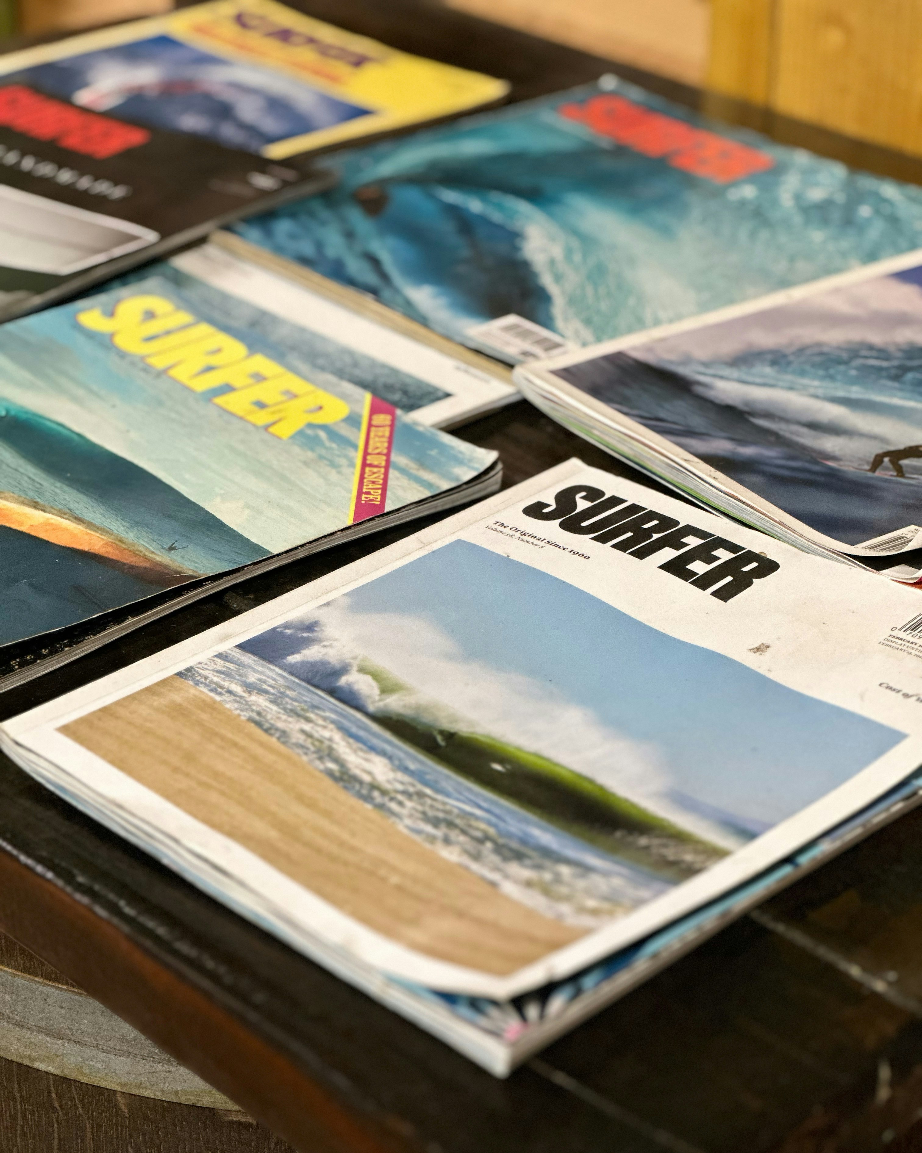 A bunch of magazines sitting on top of a table photo – Free San diego