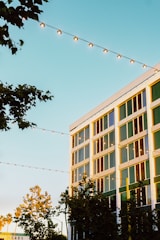 A modern building facade at 125 Cherry Street glowing warmly at sunset.