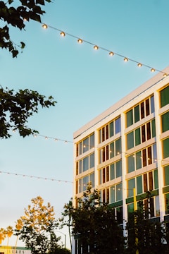 A modern building facade at 125 Cherry Street glowing warmly at sunset.