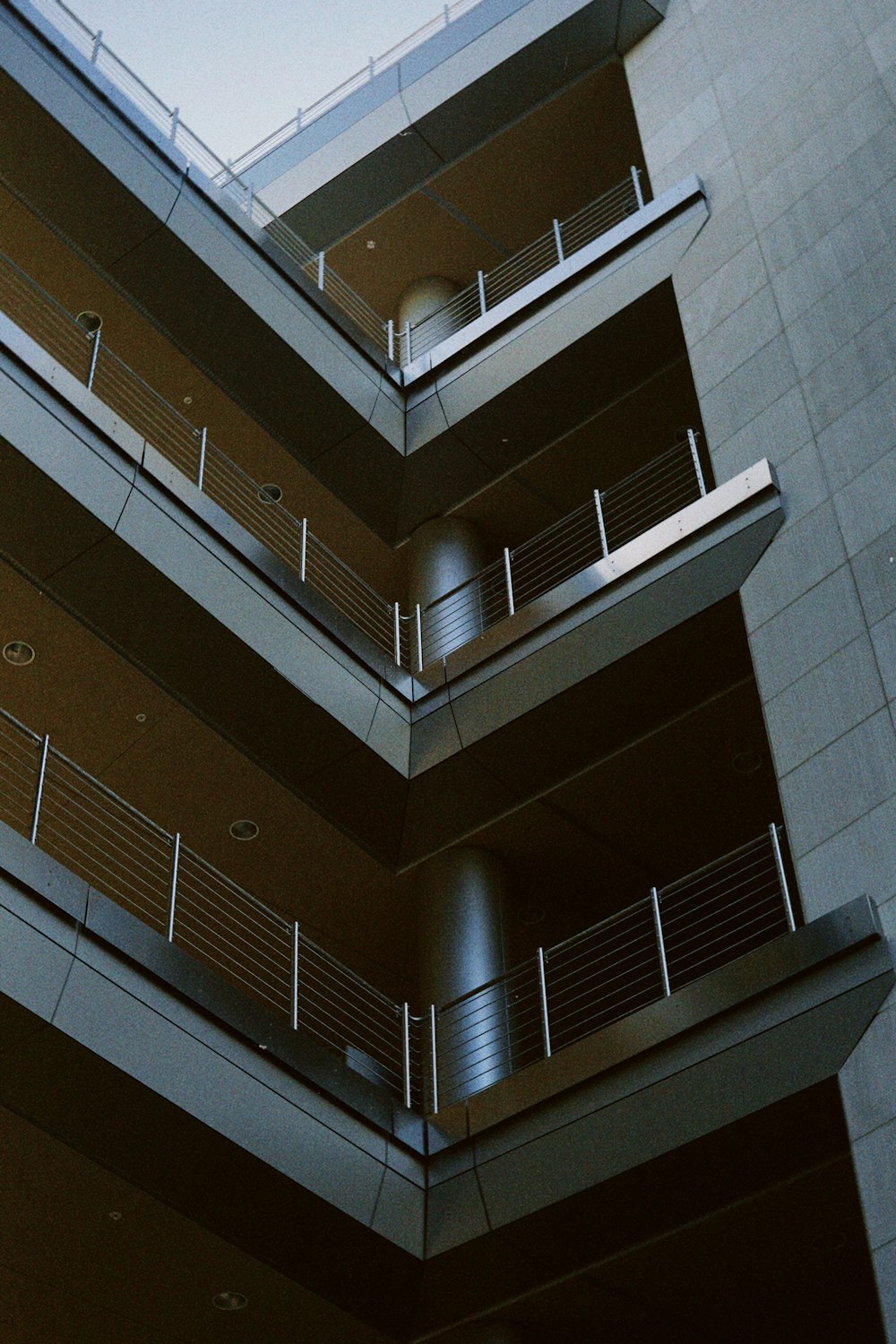 a tall building with balconies and a clock on the side