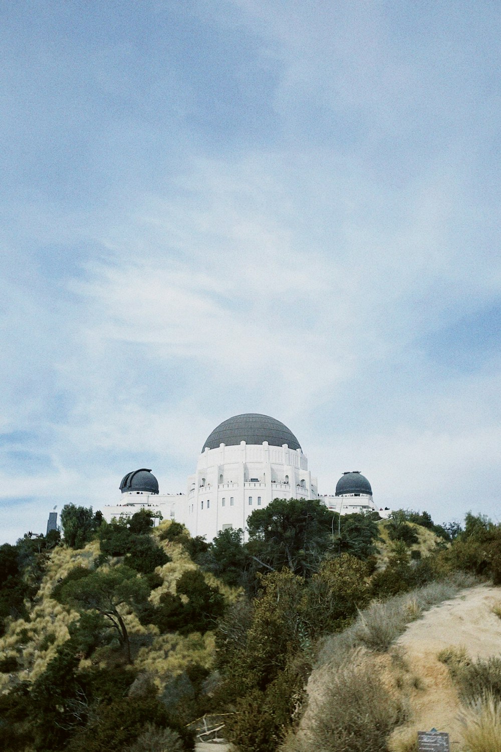 a large white building on top of a hill