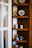 A cozy living room corner featuring elegant ceramic decorative figures on a wooden shelf.