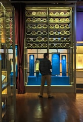 A collection of ancient scrolls and manuscripts displayed on a wooden table.