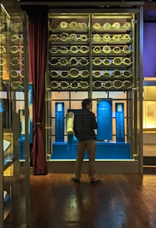 Venerable Soepa carefully examining a fragile scroll in a dimly lit monastery archive.