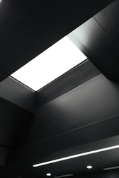 Modern drywall ceiling with custom-designed light fixtures and clean lines.