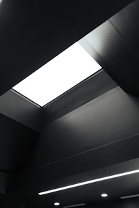 Modern drywall ceiling with custom-designed light fixtures and clean lines.