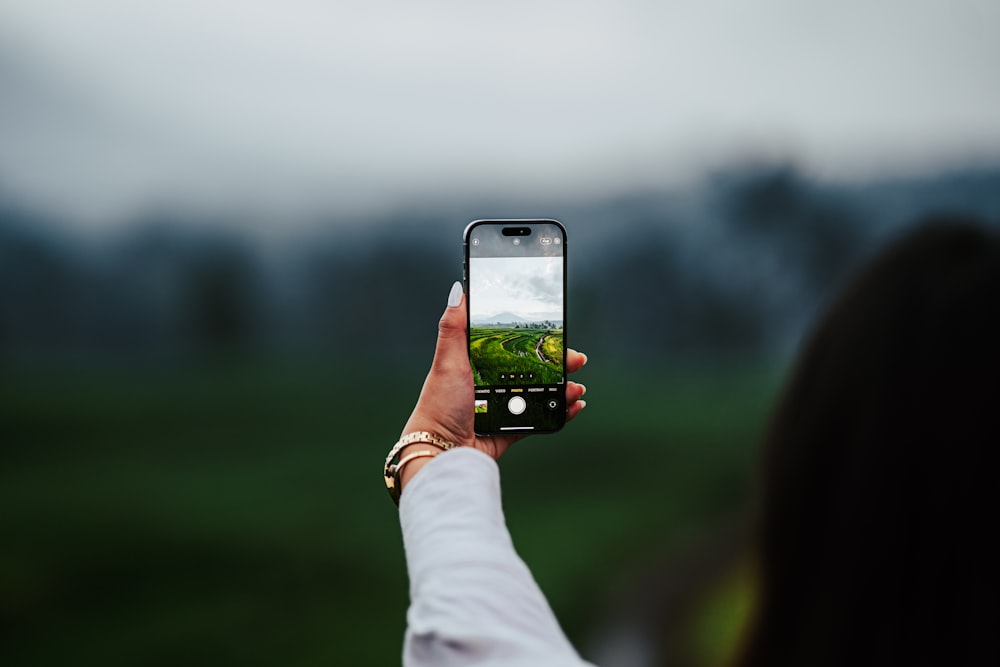 a person taking a picture with a cell phone