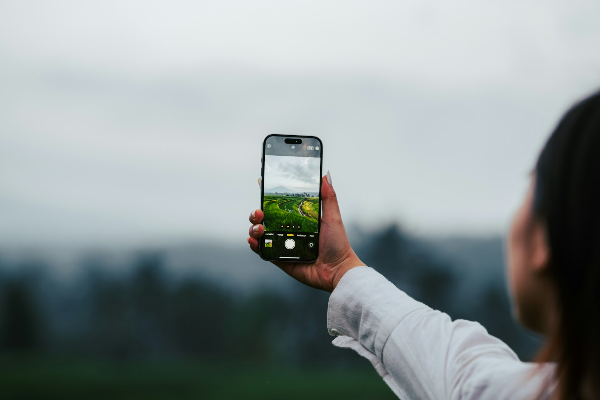 a woman taking a picture with her cell phone