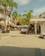 A lively street scene in Florida with tourists enjoying local shops and palm trees.