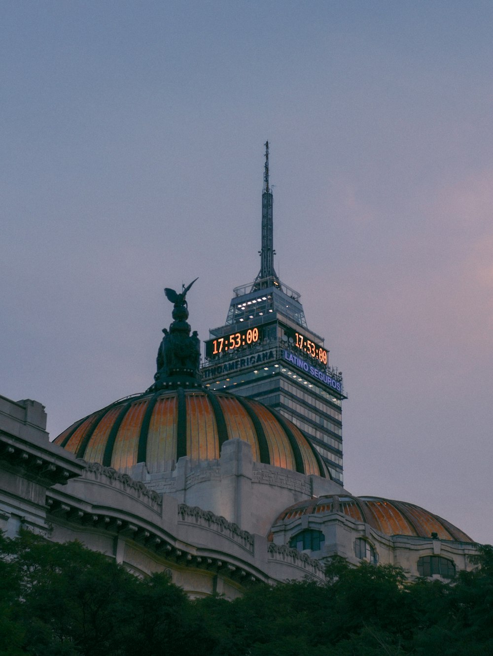 a tall building with a statue on top of it