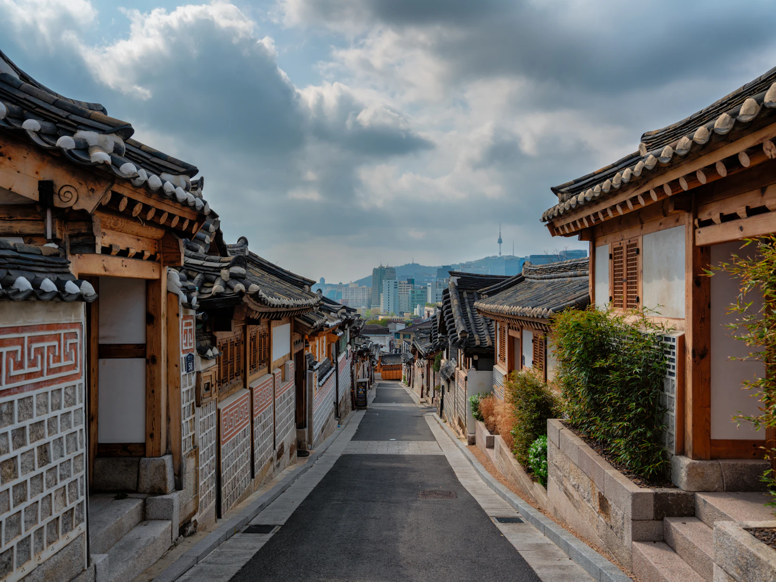 Traditional hanok street in Seoul with N Seoul Tower in the distance