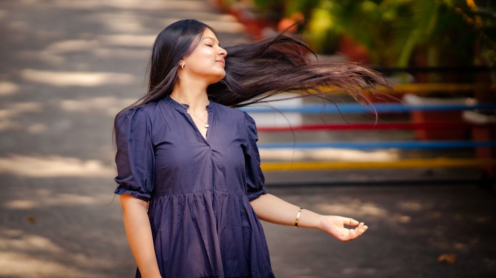 a woman with her hair blowing in the wind