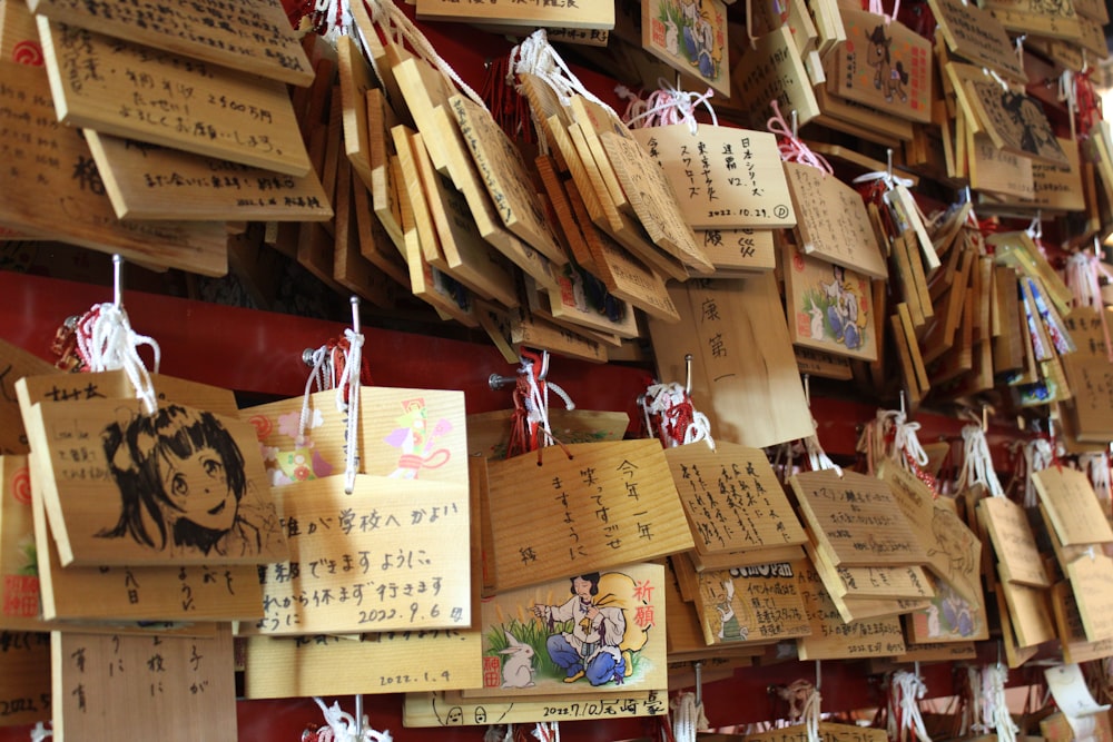 a wall covered in lots of wooden signs