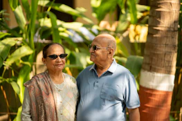 An older couple enjoying a peaceful moment outdoors, feeling connected and cared for.