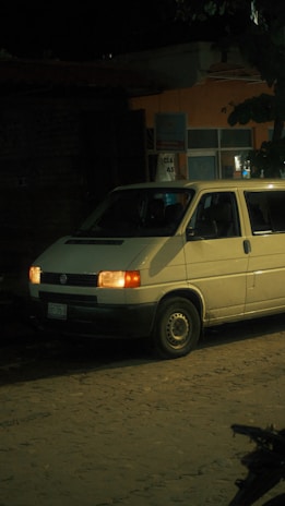 An emergency locksmith vehicle parked in front of a house at night.