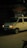 Nighttime locksmith service van parked outside a residential building.