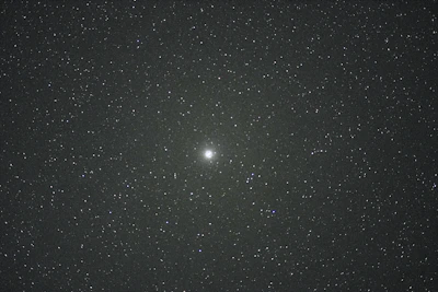 A glowing kundli chart with celestial symbols against a starry night sky.