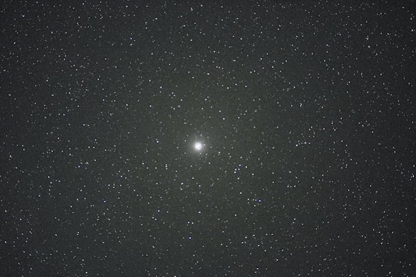 A vibrant illustration of the Aries zodiac symbol glowing against a starry night sky.