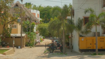 A technician performing a routine property inspection on a sunny Puerto Rico street.