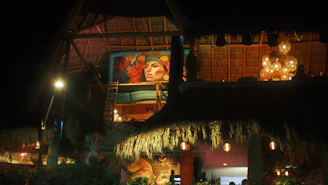 Warm, inviting interior of Bachata Rosa with tropical decor and soft golden lighting.