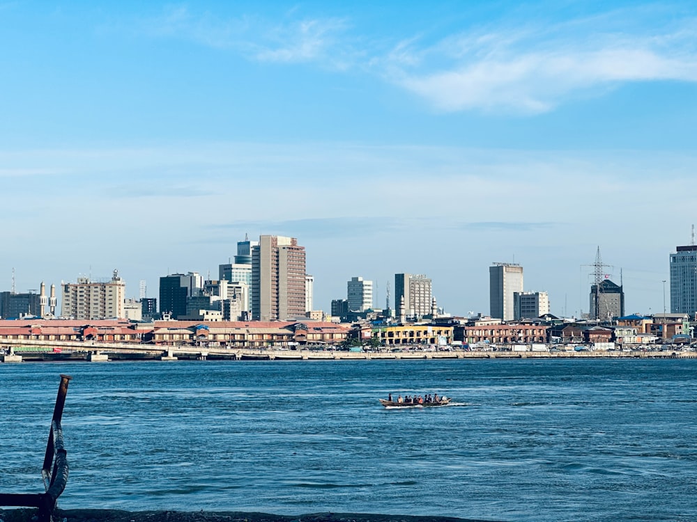 a body of water with a city in the background