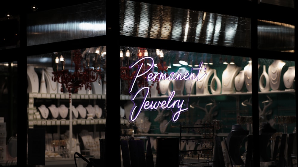 a store front with a neon sign in the window