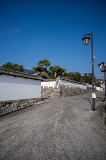 A serene Buenos Aires street at dawn with soft white and light blue tones.