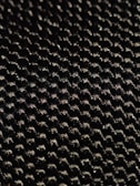 A close-up of a textured woven material displaying a pattern of small interlocking fibers with a glossy sheen under light.