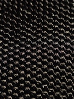Close-up of a Lumina Apparel shirt highlighting the fine stitching and unique fabric texture under natural light.