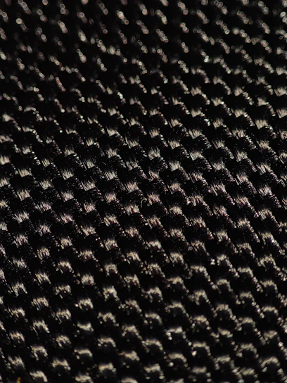 Close-up of a sleek golf polo fabric showing its breathable texture under natural sunlight.
