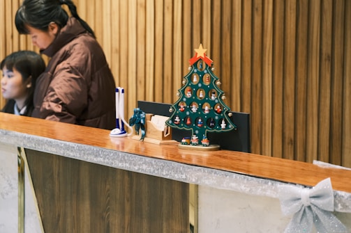 A warmly lit reception desk at a festive event venue with colorful decorations.