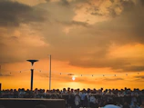 Sunset view over the event location with attendees gathered around.
