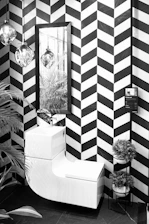 A sleek modern bathroom showcasing a white ceramic toilet and matching basin.