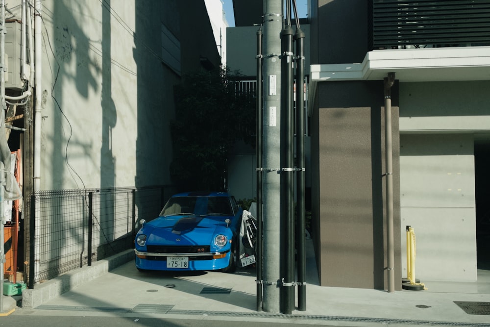 a blue sports car parked on the side of a street