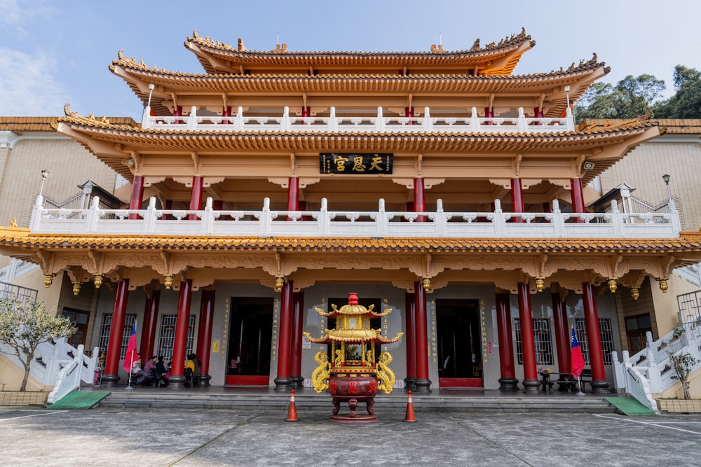 a chinese building with a statue in front of it