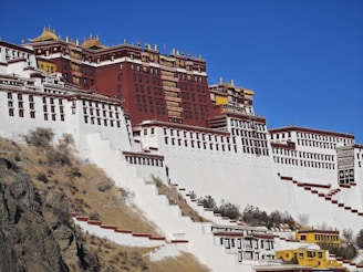 a large white and red building on top of a hill