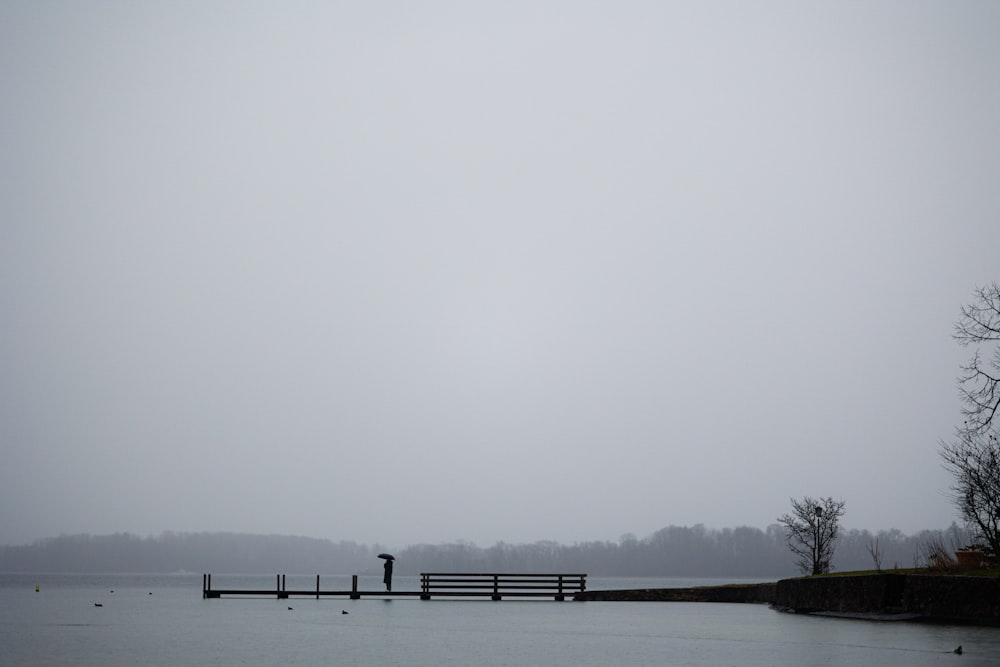 a body of water with a dock in the middle of it