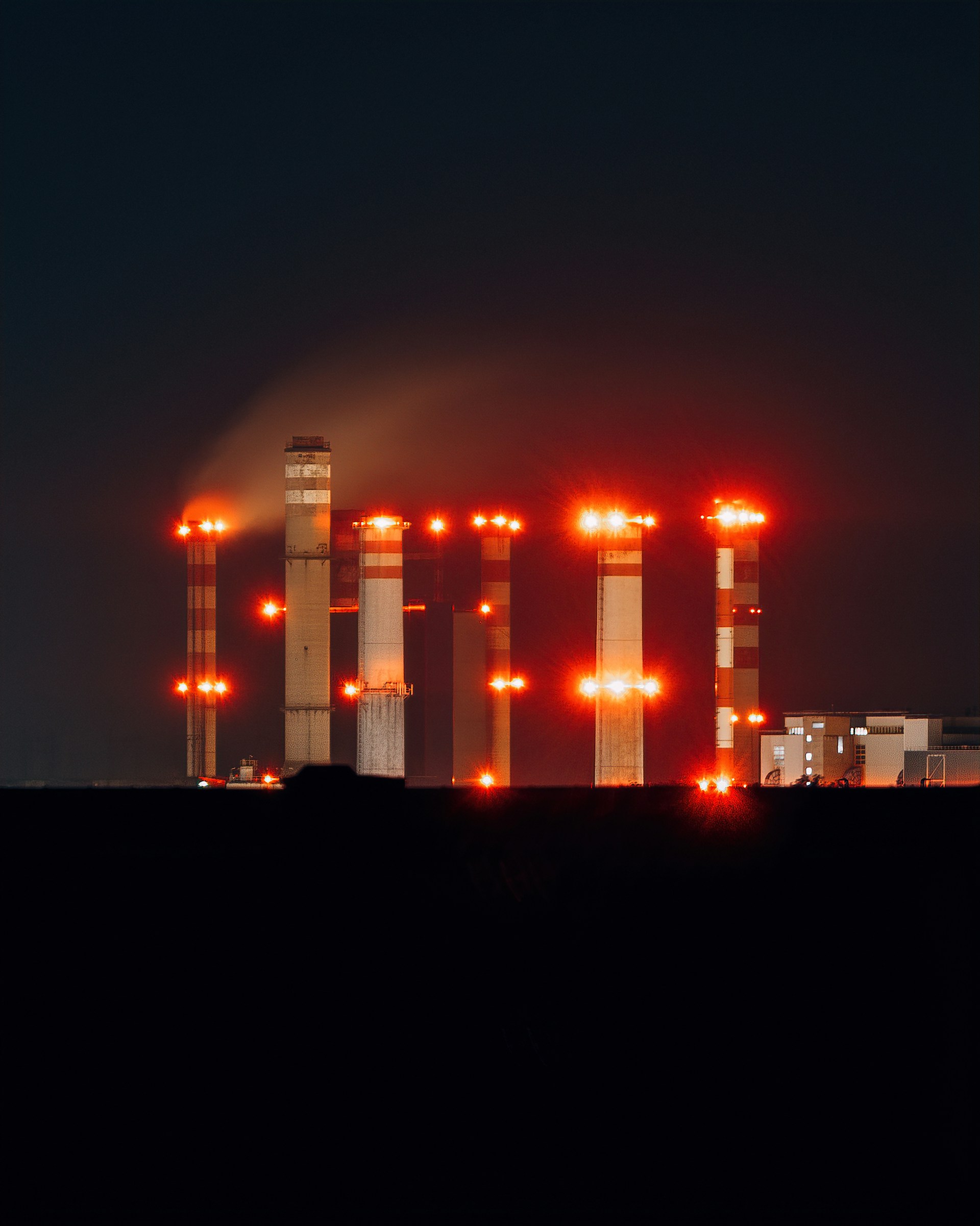 a factory with a lot of red lights on it