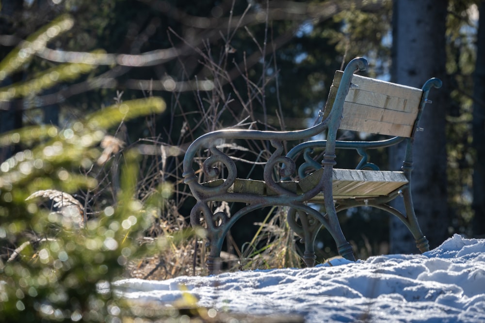 a bench sitting in the middle of a snow covered field