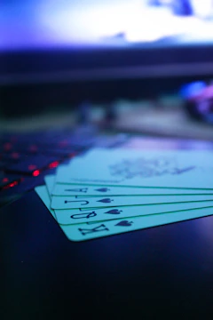Close-up of a winning 3Patti hand with glowing cards on a wooden table.