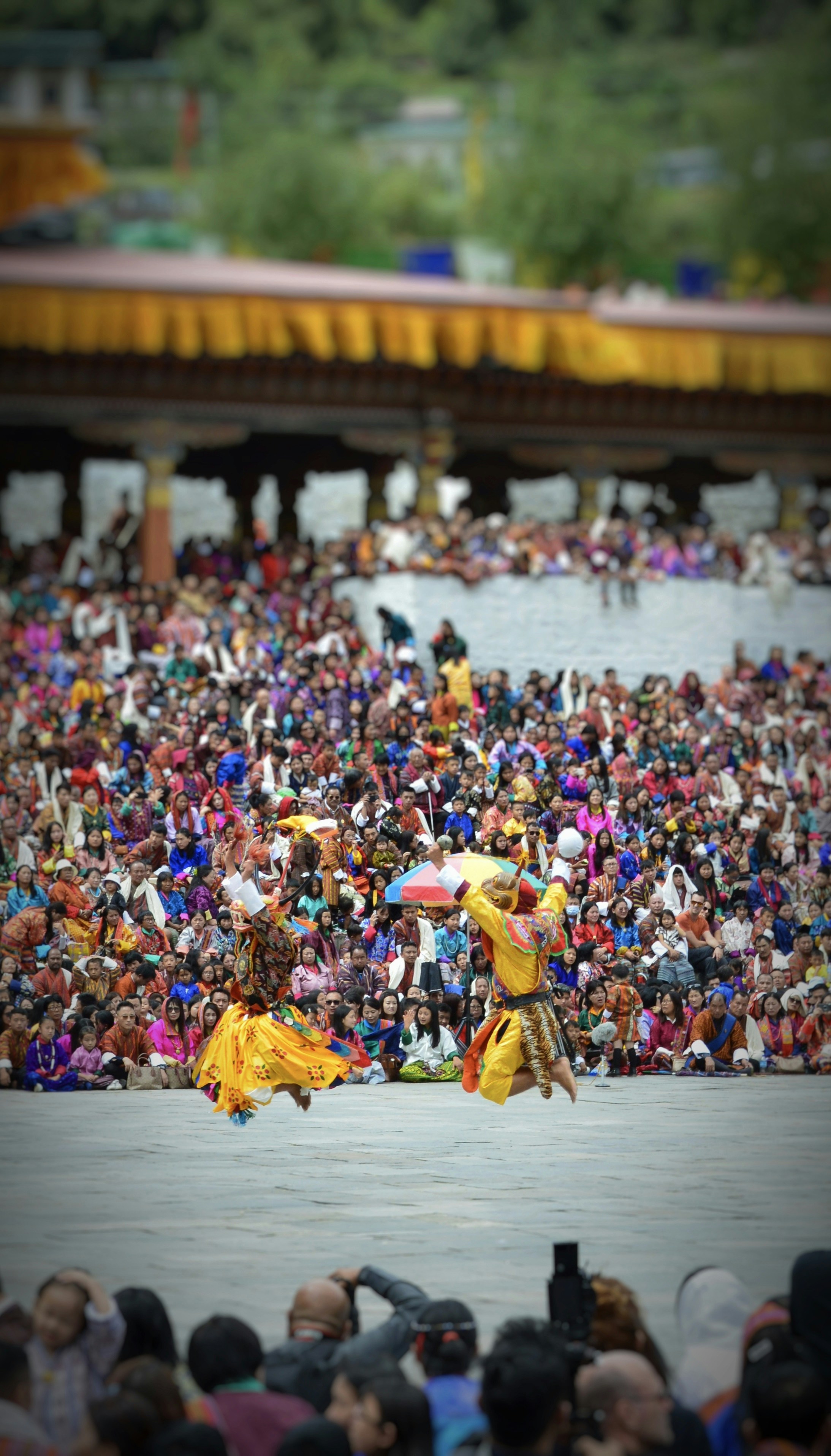 Carnival dancers in orange and yellow costumes performing on stage