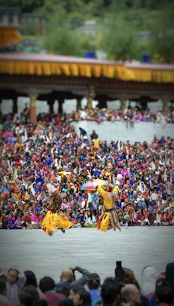 Colorful dancers in traditional Tunisian costumes performing at a lively outdoor festival.