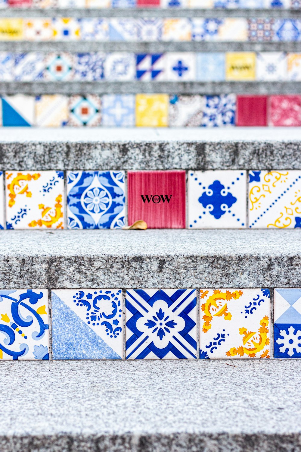 a close up of a set of stairs with colorful tiles