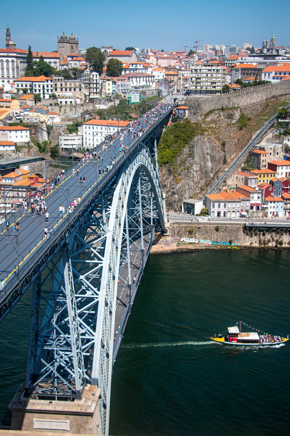 a large bridge over a river with a boat on it