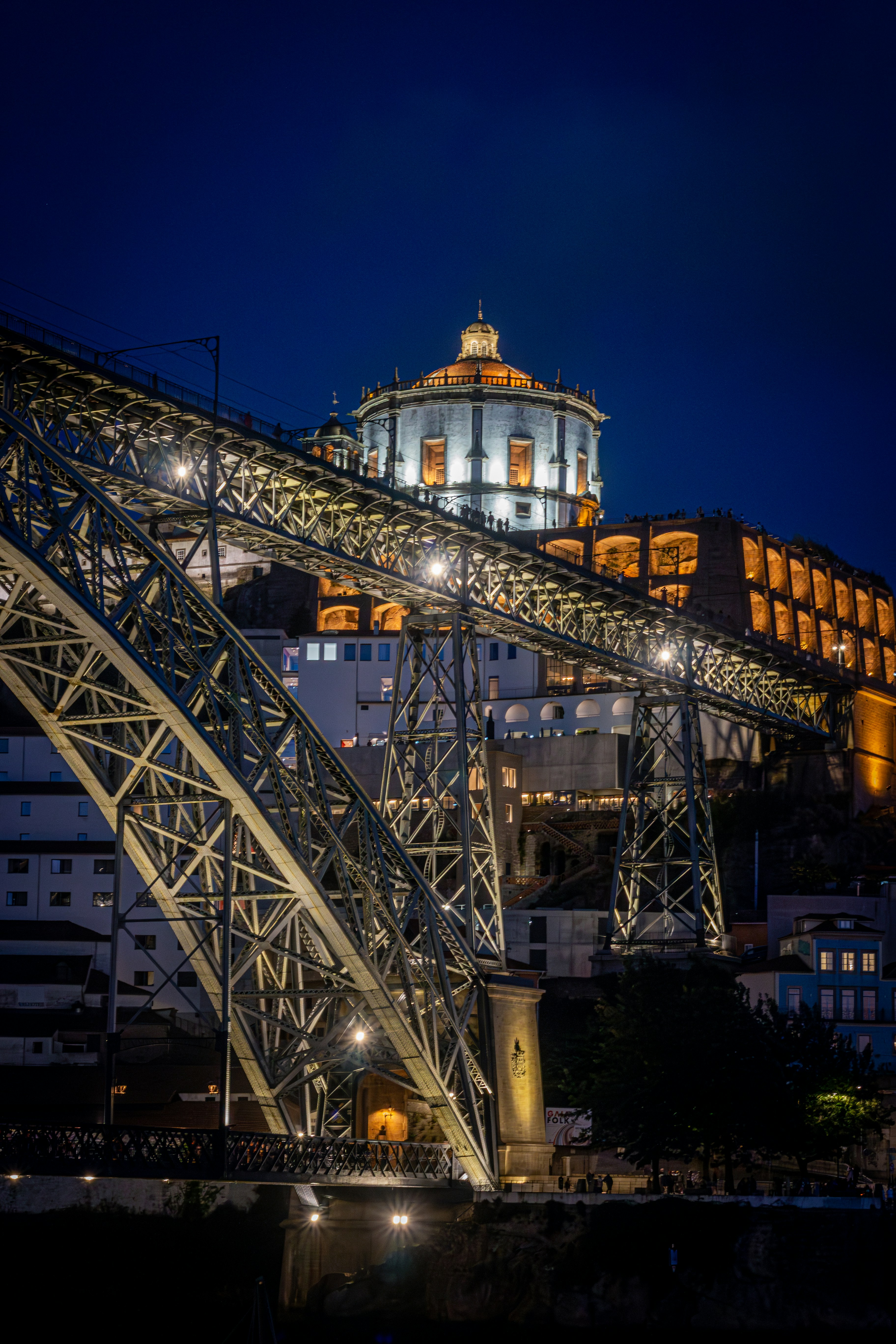 a large metal structure with a clock tower in the background