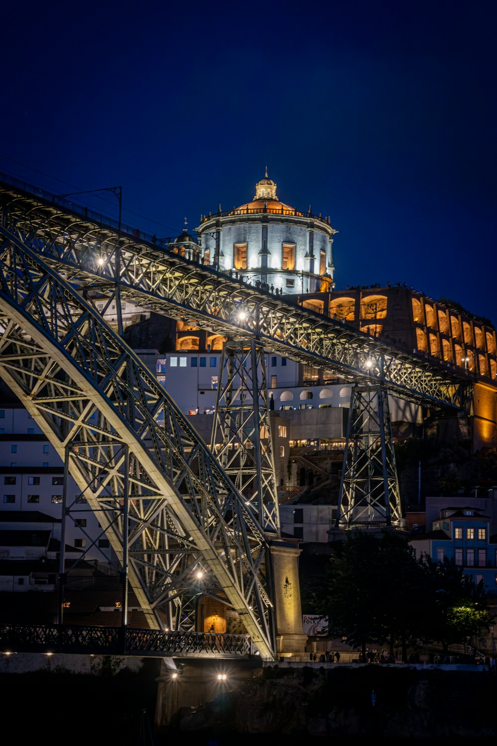 a large metal structure with a clock tower in the background