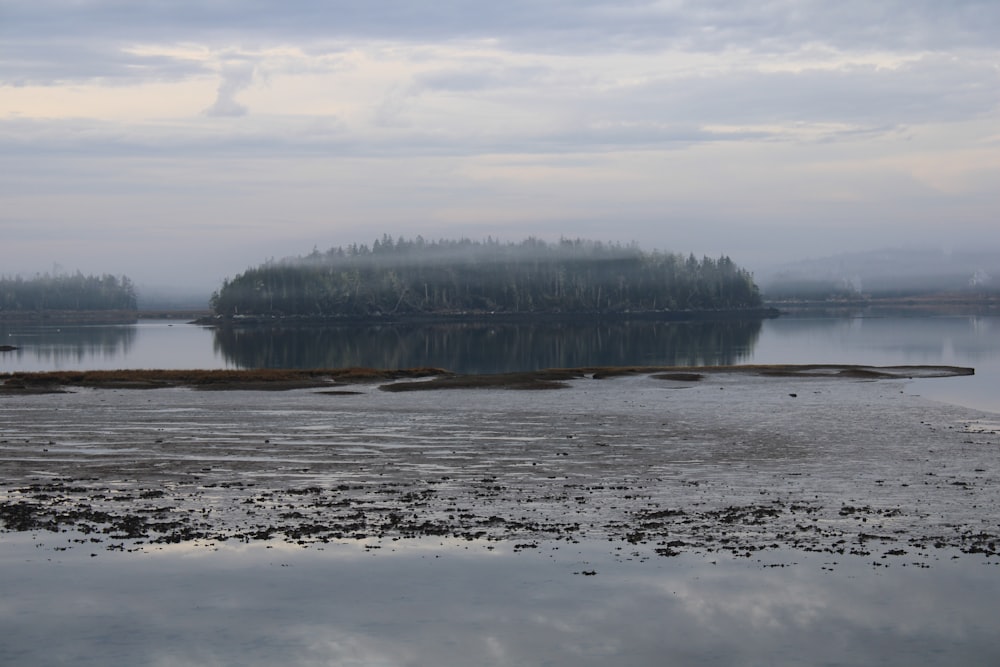 a body of water with a small island in the middle of it