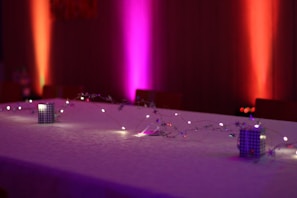 A beautifully decorated mobile bar setup with string lights and happy guests around.